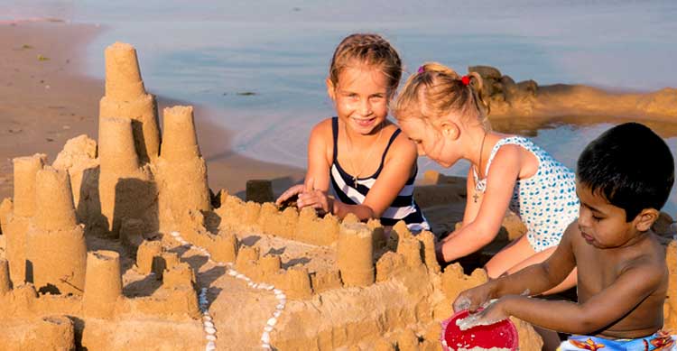 Children building sandcastle